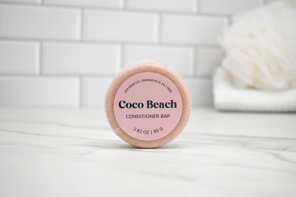 Coco Beach conditioner bar on a white surface with a tiled wall background