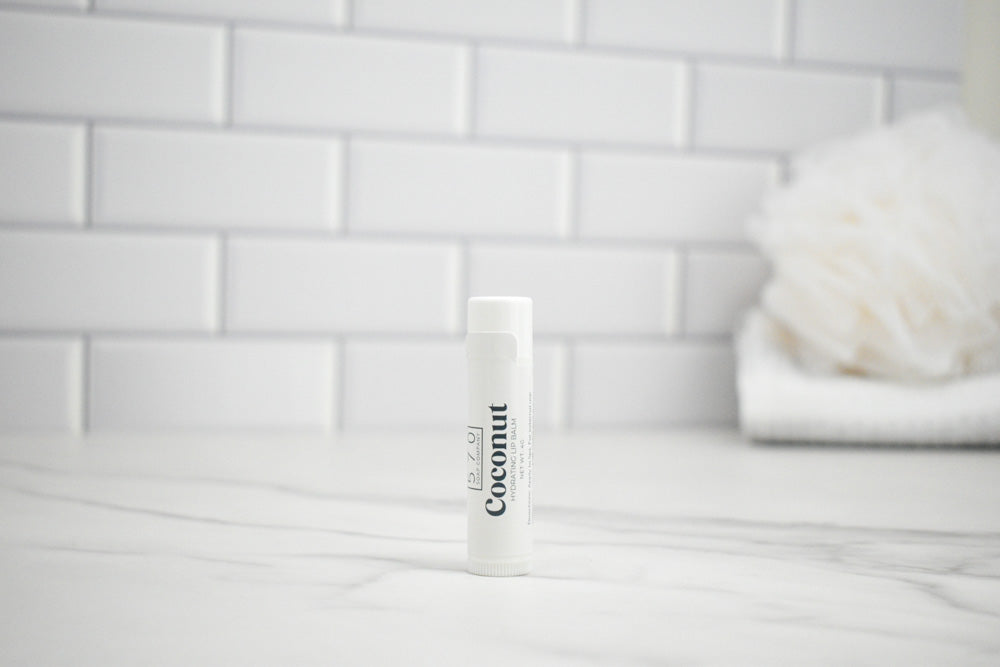 White tube labeled 'Coconut' on a white surface with a tiled wall background