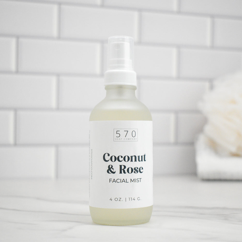 Bottle of Coconut & Rose Facial Mist with a white label on a light gray surface.