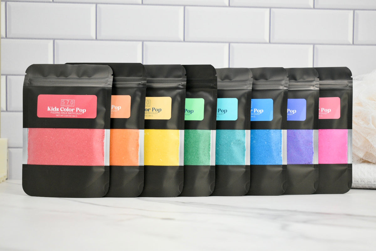 Set of black bags with colorful labels on a white surface and tiled wall background