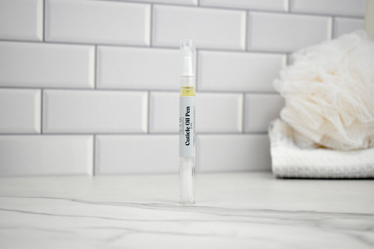 Clingy Stylus Pen on a bathroom counter with white tiles in the background