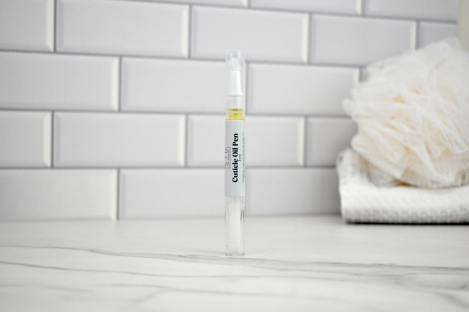 Clingy Stylus Pen on a bathroom counter with white tiles in the background