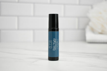 Skincare serum bottle labeled 'Date Night' on a white surface with a tiled wall background