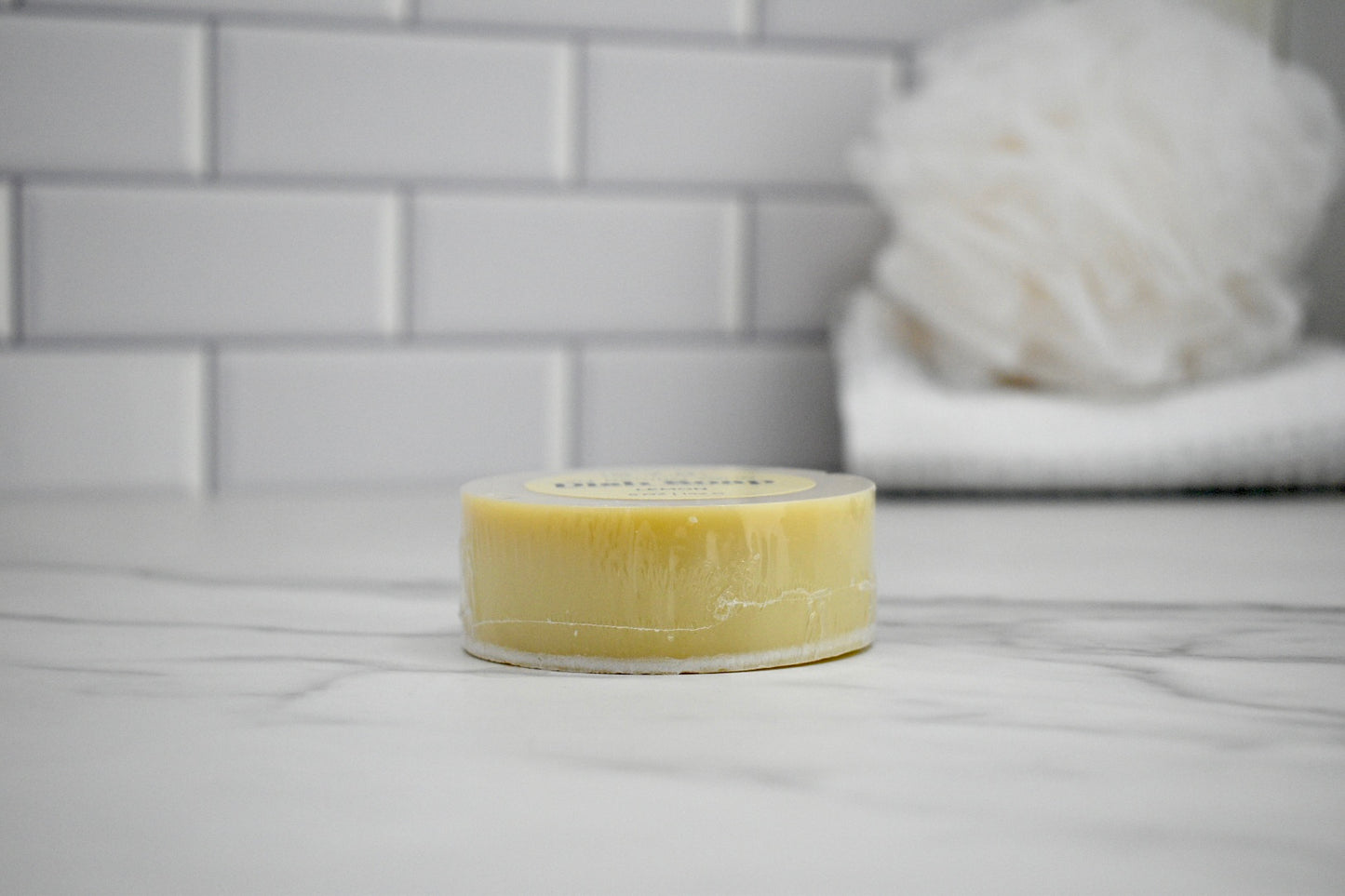 Bar of soap on a bathroom counter with a blurred background