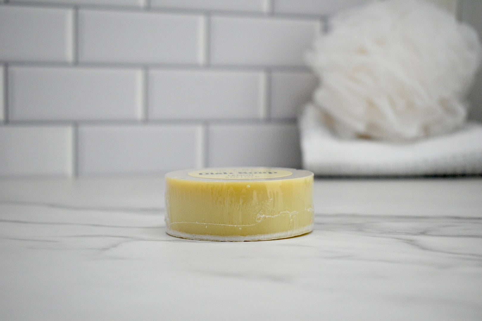 Bar of soap on a bathroom counter with a blurred background