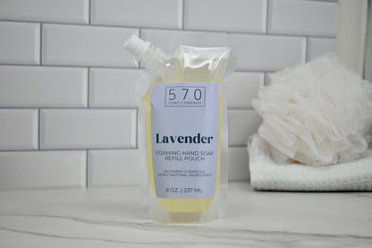Foaming hand soap refill pouch with lavender scent on a bathroom counter.