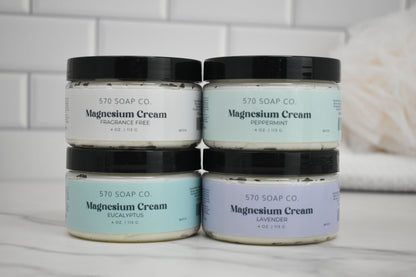 Four jars of 570 Soap Co. magnesium cream on a bathroom counter.