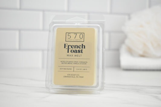 French Toast wax melt packaging on a white surface with a blurred background