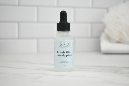 Bottle of 570 Fresh Mint Eucalyptus fragrance oil with dropper on a white tiled background