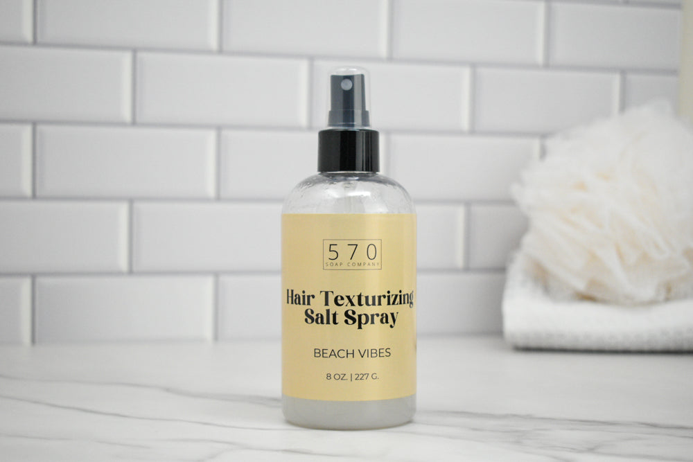 Bottle of 570 Hair Texturizing Salt Spray on a tiled bathroom counter