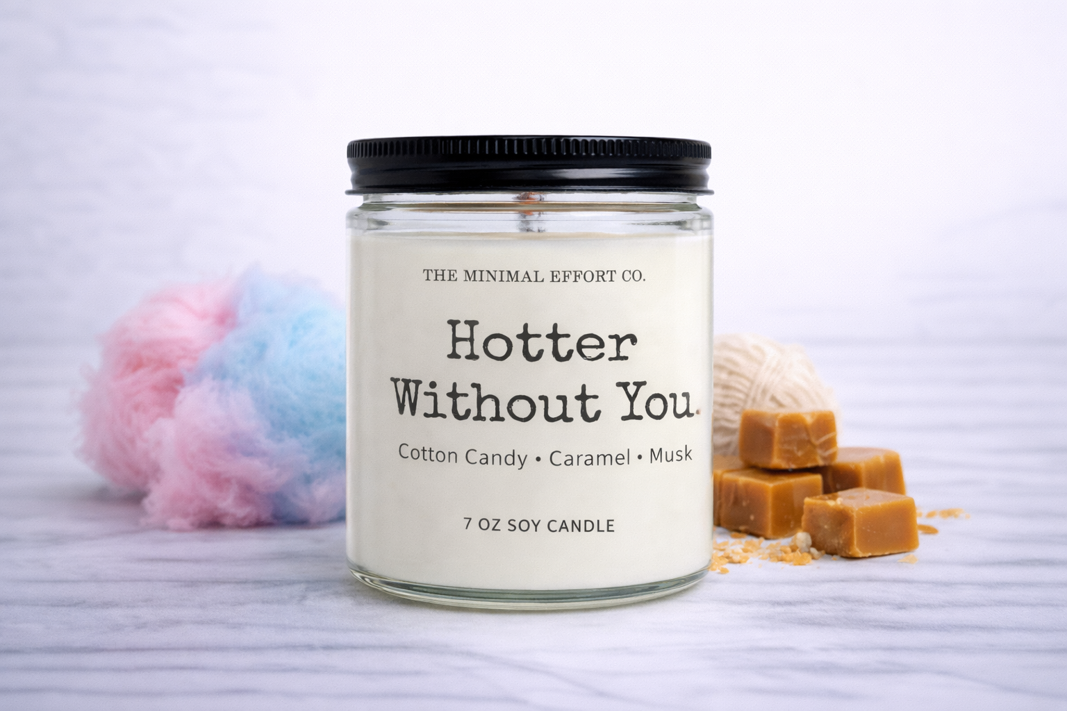 Candle jar with 'Hotter Without You' description on a light background