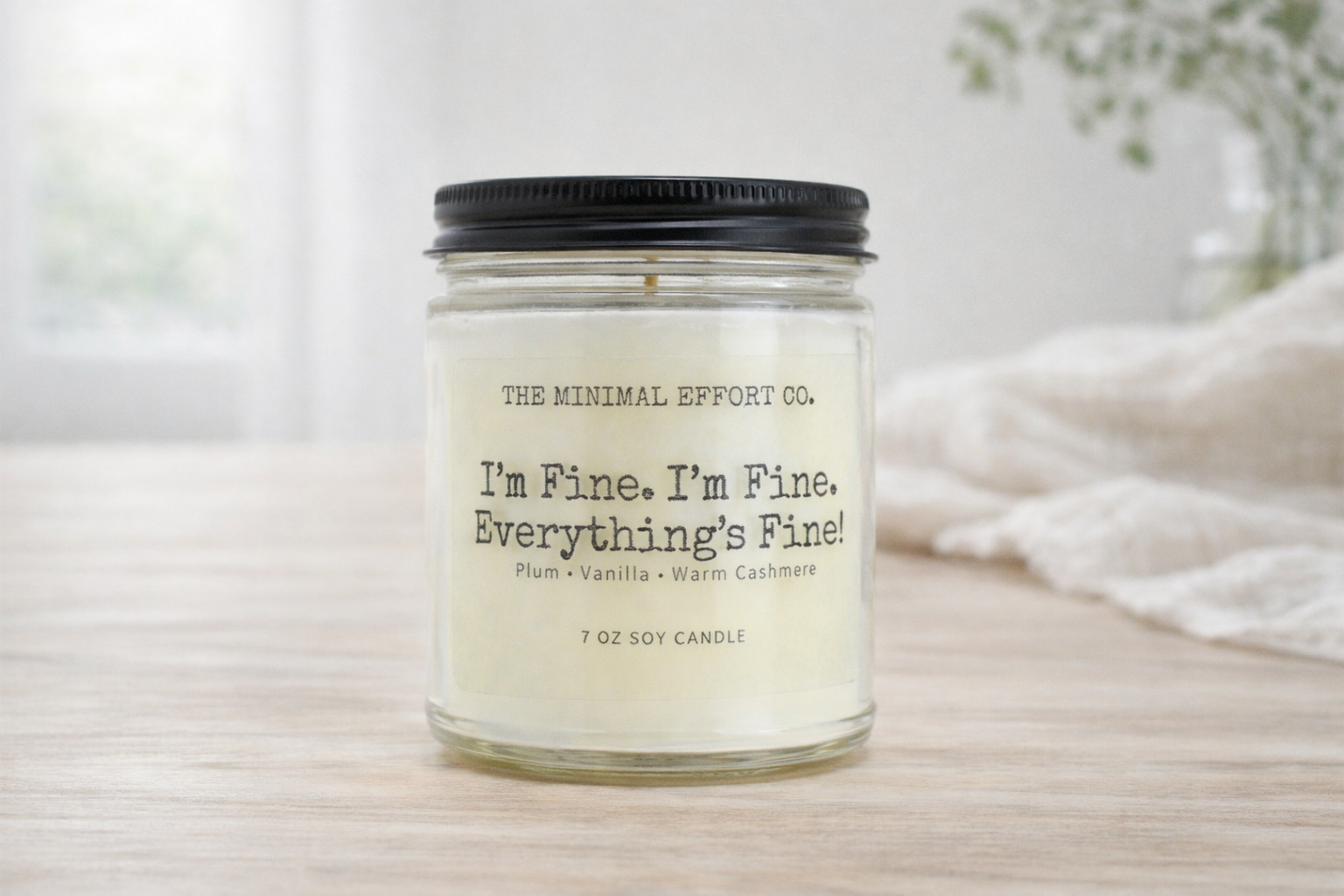 Candle with a label on a wooden surface
