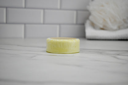 Bar of soap on a bathroom counter with tiled wall in the background