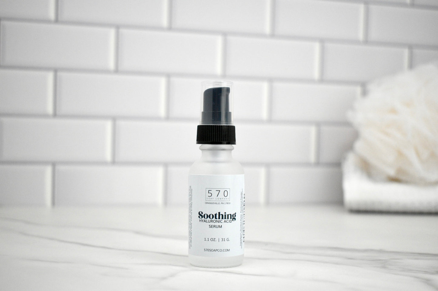 Bottle of 570 Soothing Lotion on a bathroom counter with a white tiled wall background.