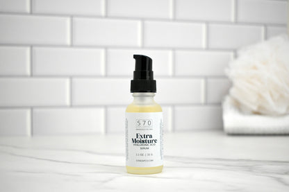 Bottle of 57.0 Extra Moisture Serum on a white tiled bathroom counter