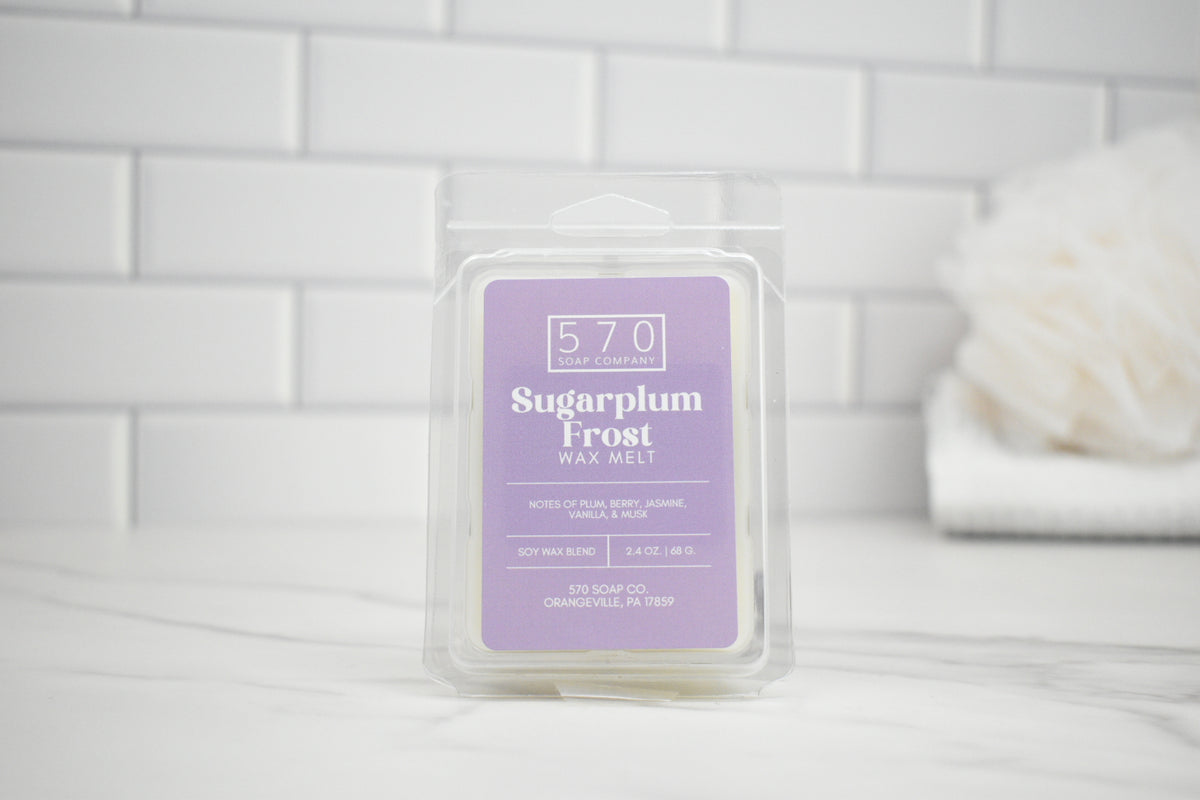 Packaged wax melt labeled 'Sugarplum Frost' on a white tiled background