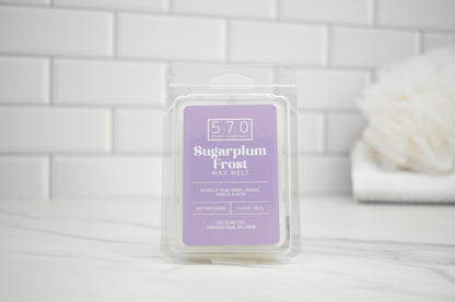 Packaged wax melt labeled 'Sugarplum Frost' on a white tiled background
