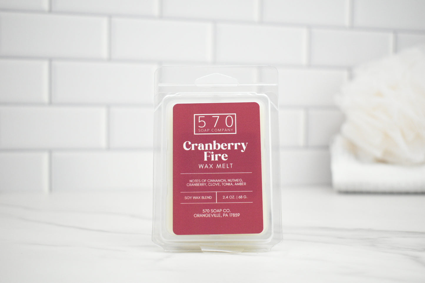 Cranberry Fire wax melt packaging on a white tiled background