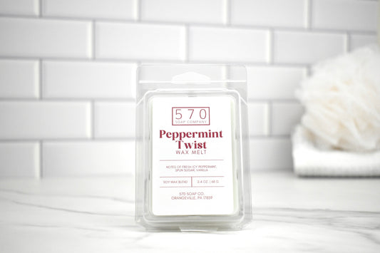 570 Peppermint Twist wax melt packaging on a white surface with a tiled wall background