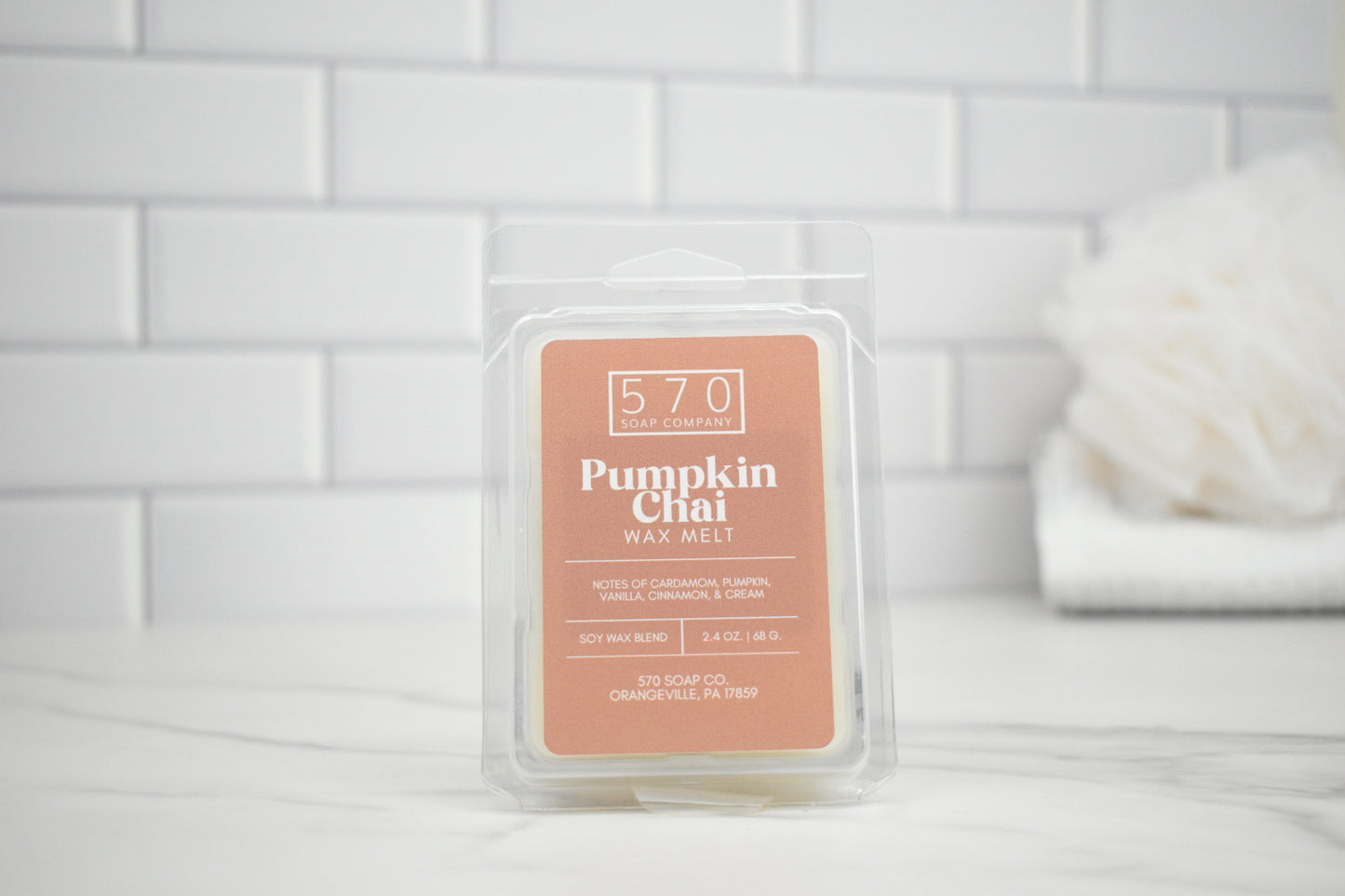 Pumpkin Chai wax melt packaging on a white tiled background