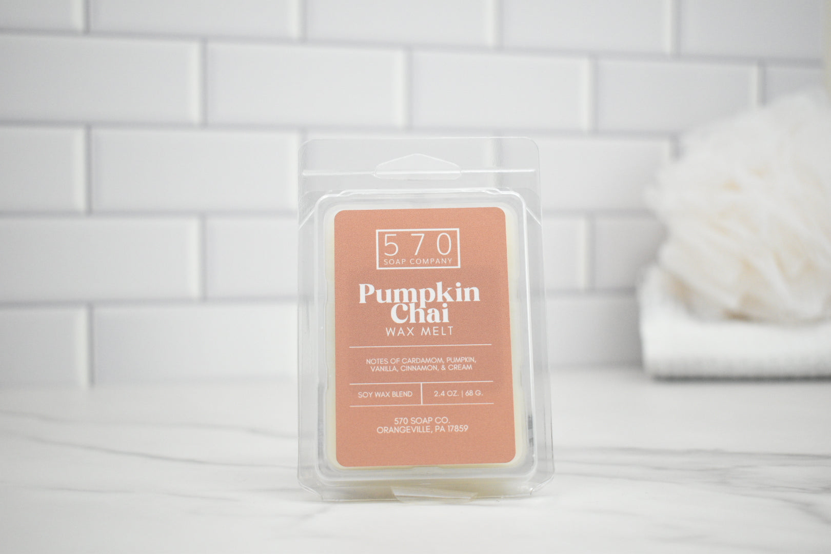 Pumpkin Chai wax melt packaging on a white tiled background