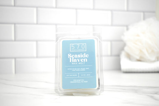 Wax melt packaging labeled '570 Seaside Haven' on a white tiled background
