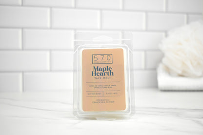570 Maple Hearth wax melt packaging on a white tiled background