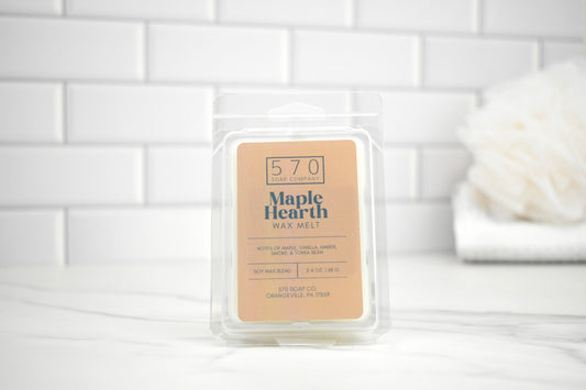 570 Maple Hearth wax melt packaging on a white tiled background