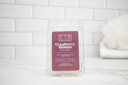 Packaged cranberry balsam wax melt with 570 Soap & Co branding on a white tiled background.