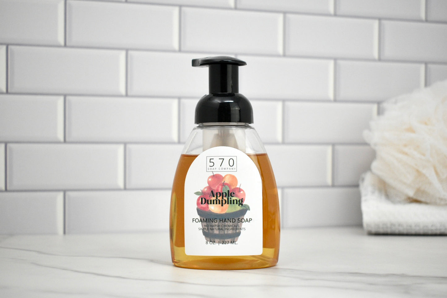 Foamed hand soap bottle with label on a bathroom counter