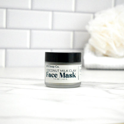 Jar of coconut milk clay face mask on a white tiled background