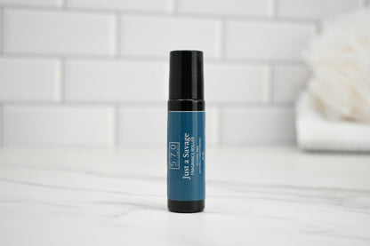 Blue skincare serum bottle with black cap on a white surface with a tiled wall background