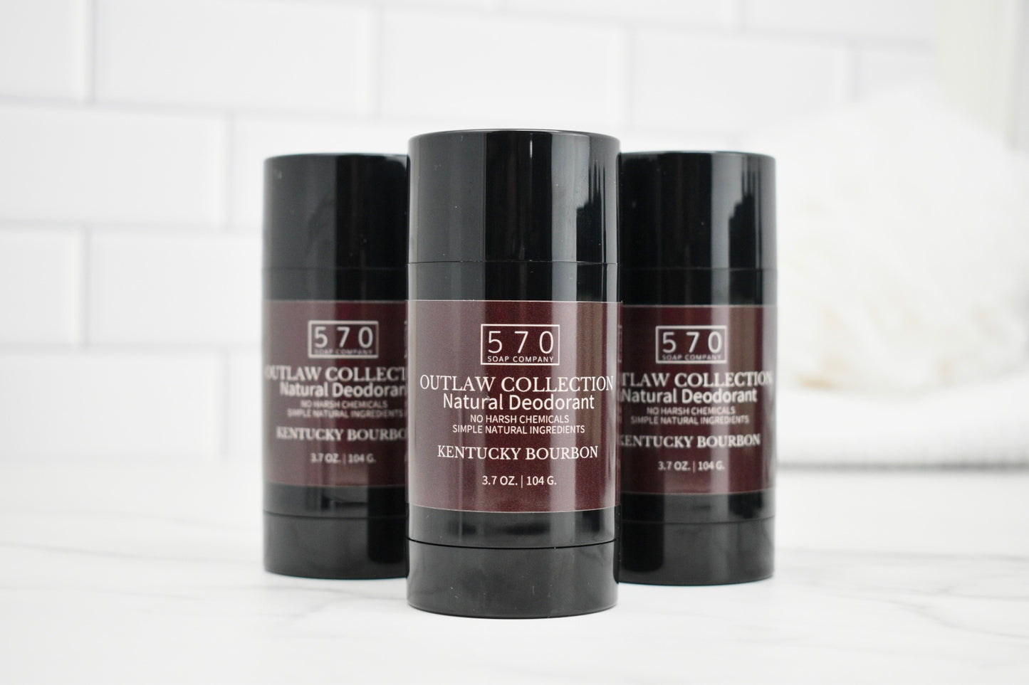 Three deodorant sticks from the 570 Outlaw Collection on a white background