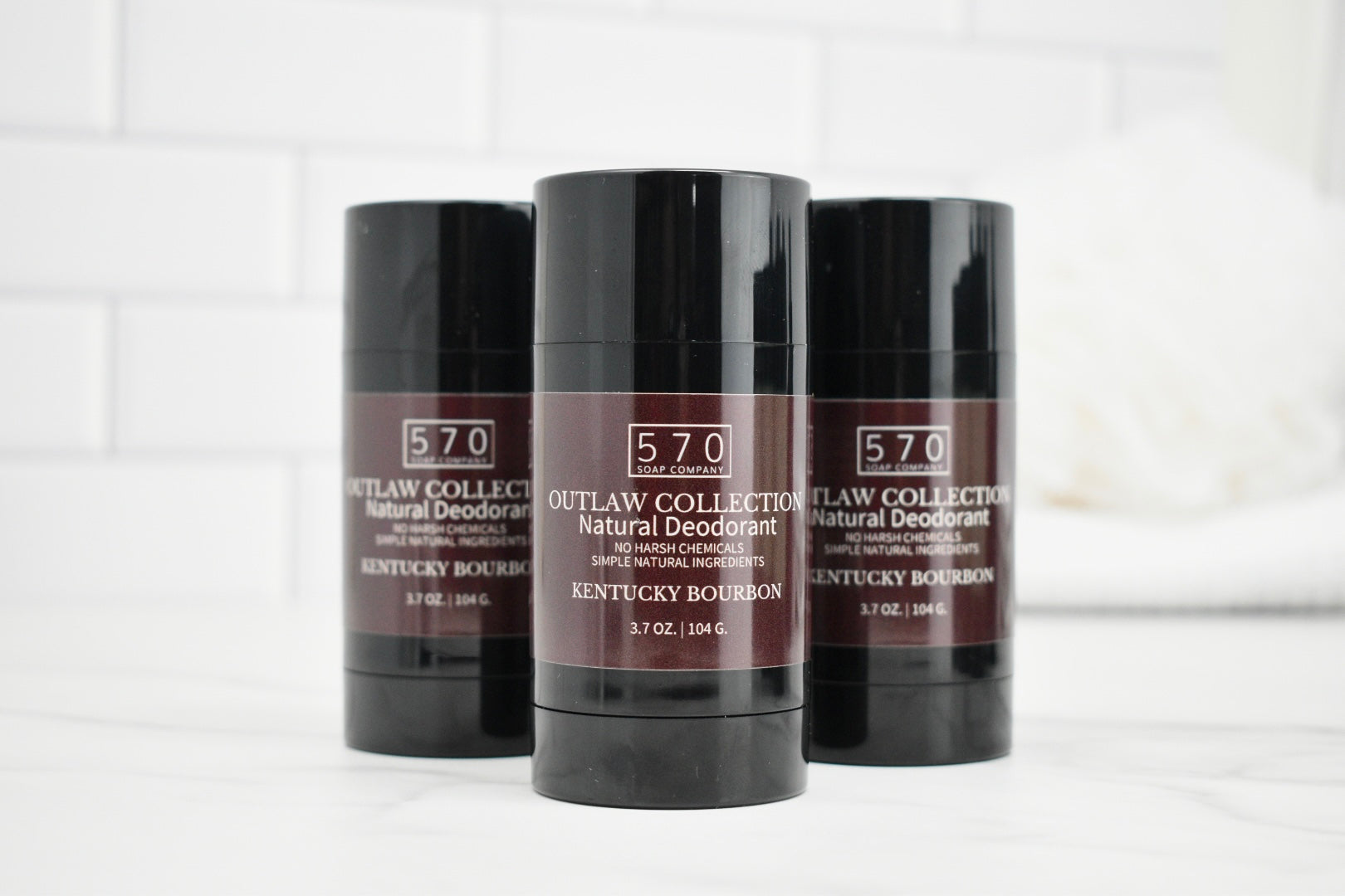 Three deodorant sticks from the 570 Outlaw Collection on a white background