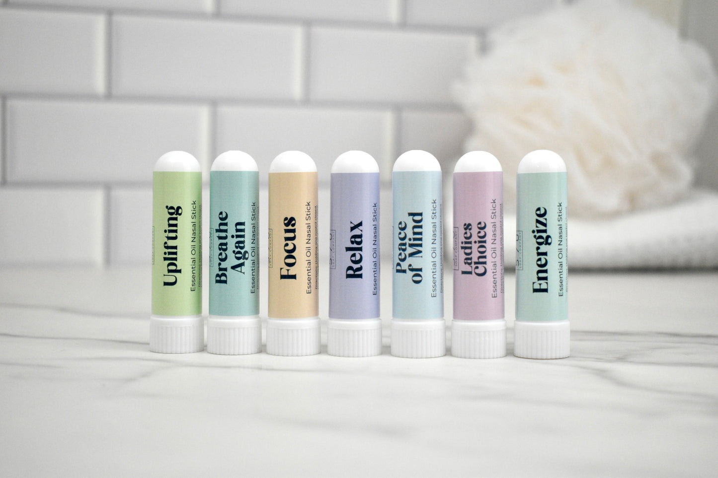 Set of nasal sticks with various scents on a white surface with a blurred background