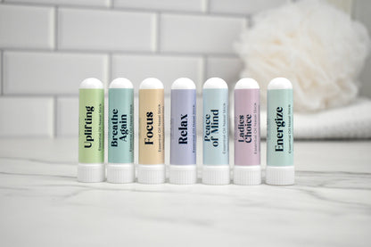 Set of nasal sticks with various scents on a white surface with a blurred background