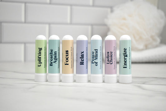 Set of nasal sticks with various scents on a white surface with a blurred background