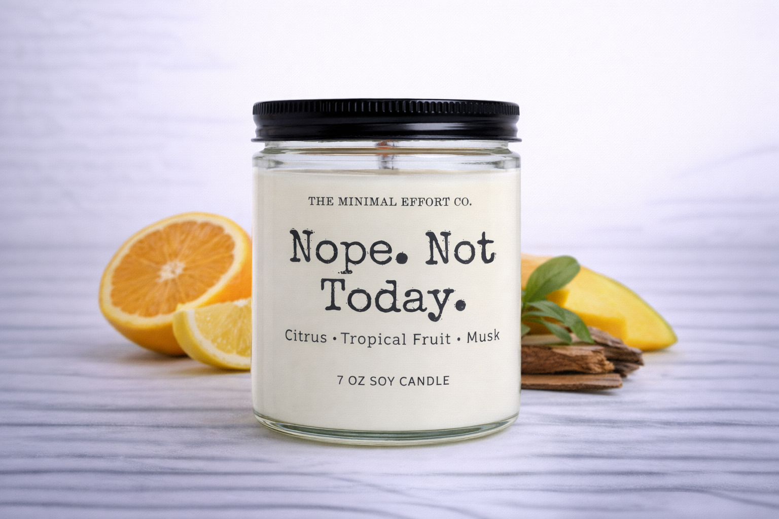 Candle labeled 'Nope. Not Today.' with citrus and tropical fruit scents on a white background
