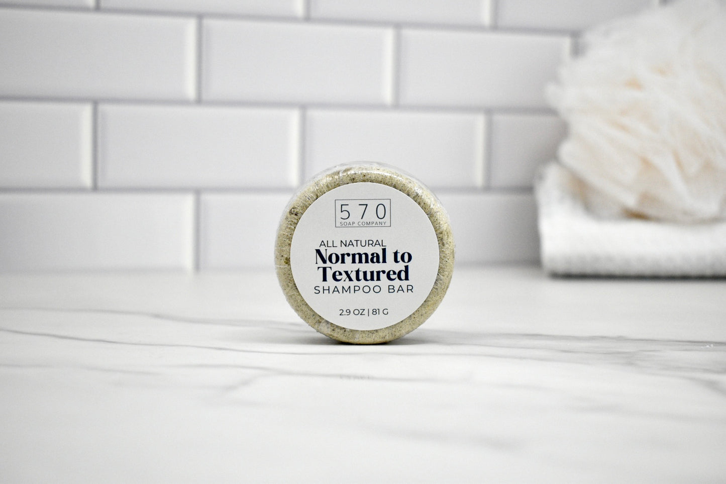 Shampoo bar with a label on a white surface