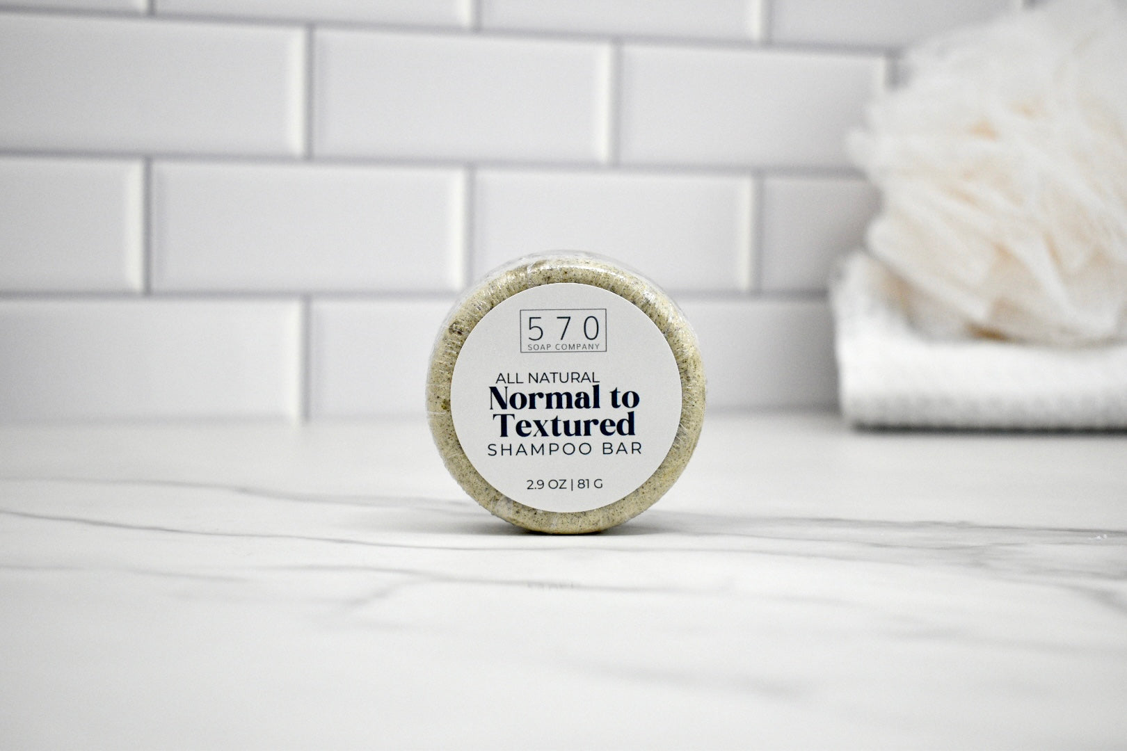 Shampoo bar with a label on a white surface
