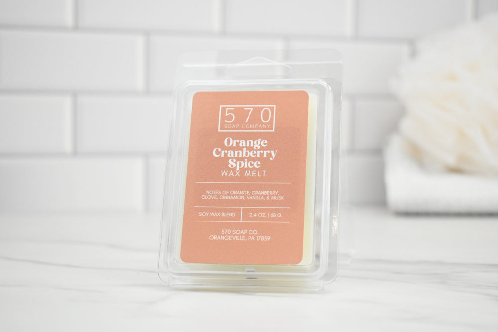 Packaged wax melt with '570' branding on a white tiled background