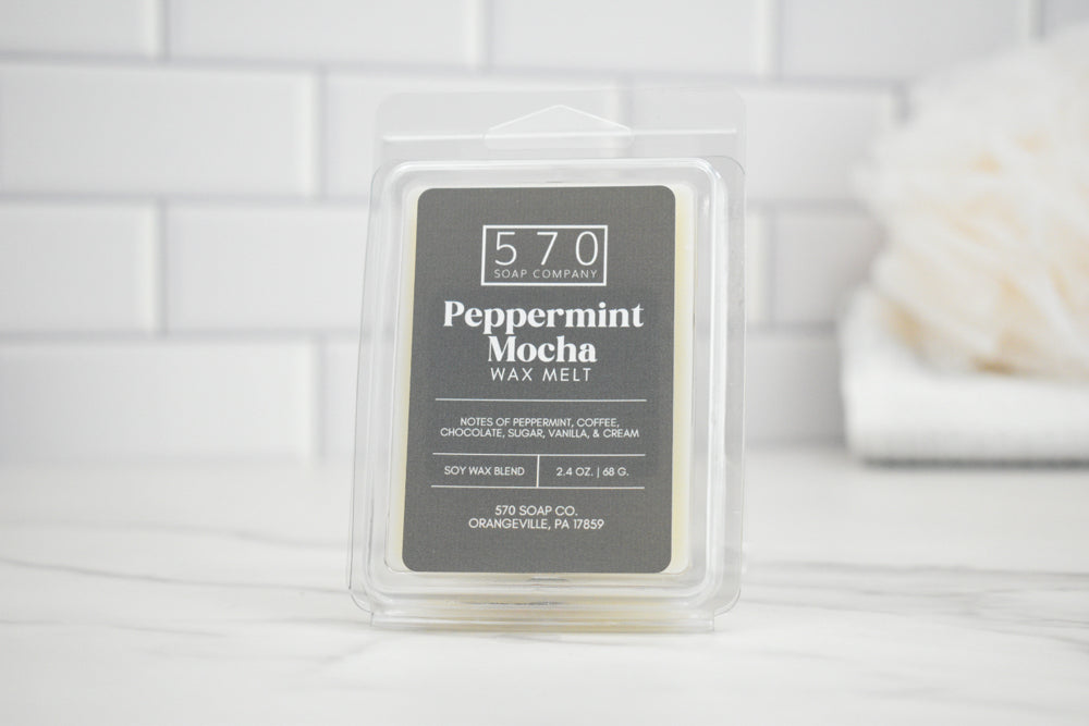 Peppermint Mocha wax melt packaging on a white surface with a blurred background