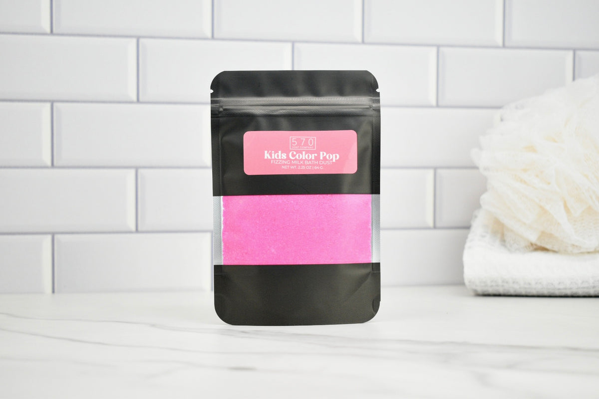 Black packaging with pink content labeled 'Kids Color Pop' on a white tiled background