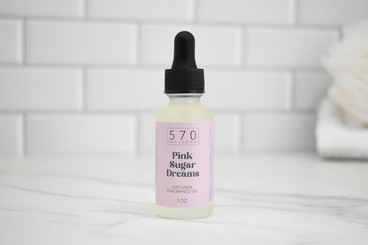 Bottle of 'Pink Sugar Dreams' diffuser oil with dropper on a white tiled background