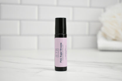 Skincare serum bottle with pink label on a white surface