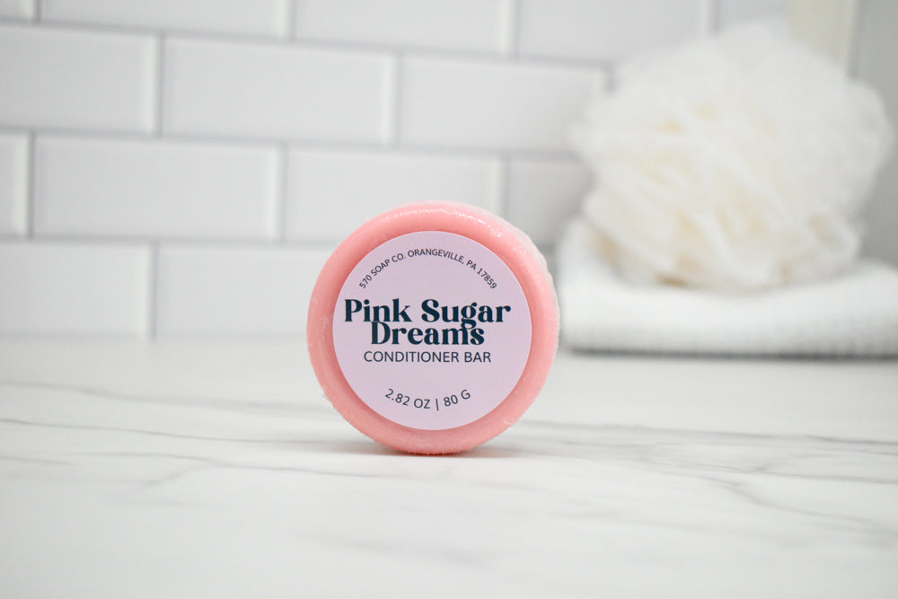 Pink Sugar Dreams conditioner bar on a white tiled background