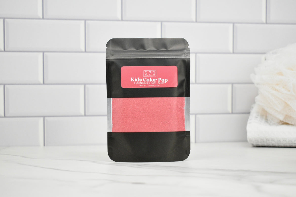 Pink powder in a black packaging bag with a pink label on a white tiled background