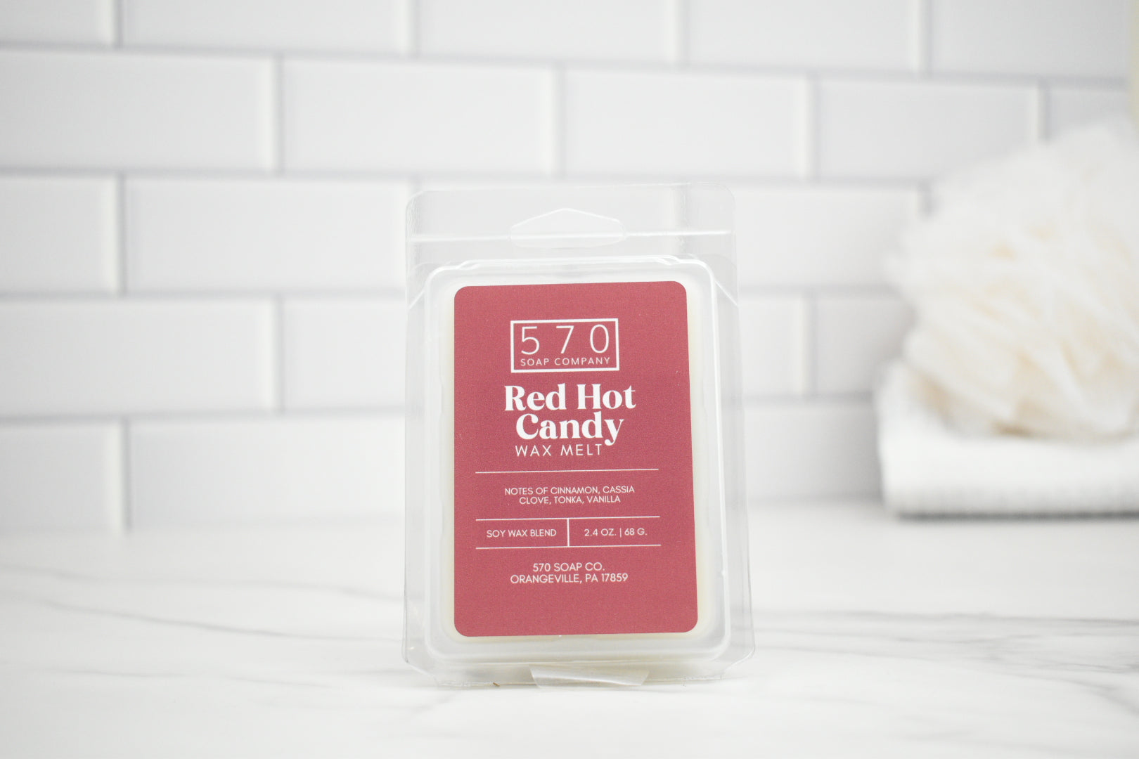 Red Hot Candy wax melt packaging on a white tiled background