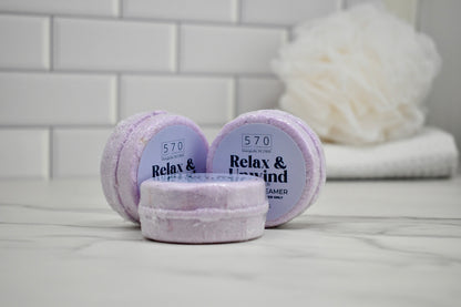 Three lavender bath bombs with '570' branding on a bathroom counter.