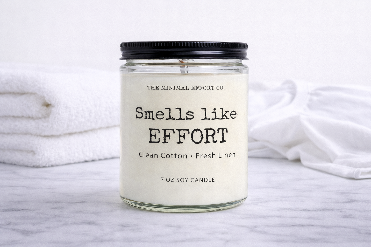 Candle with 'Smells like Effort' label on a white background